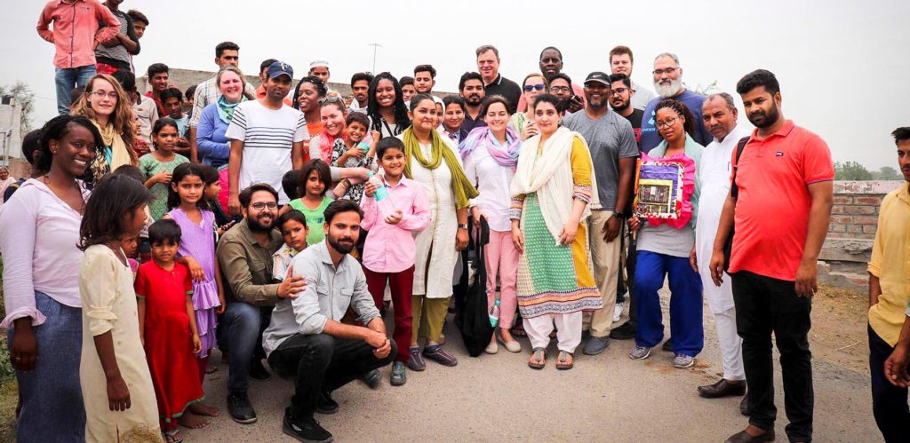 MOM students are pictured with students from Aligarh Muslim University’s School of Social Work, village residents and children.