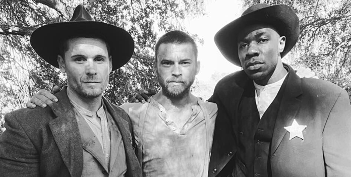 Mercer alum William Mark McCullough, center, is pictured with Linc Hand and McKinley Belcher III on the set of the western film 