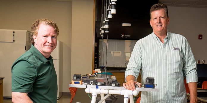 Mercer biology professor Dr. Mike and environmental engineer professor Dr. Phil McCreanor are pictured with the Baited Remote Underwater Video system they designed.