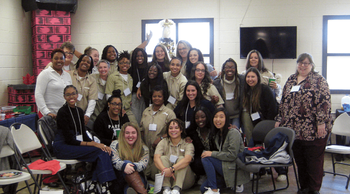 Inside-Out course an ‘enlightening experience’ for both Mercer students and inmates Mercer students and women incarcerated at Pulaski State Prison pose for photos during their last ‘Building Community/Inside-Out’ class together on Dec. 7.