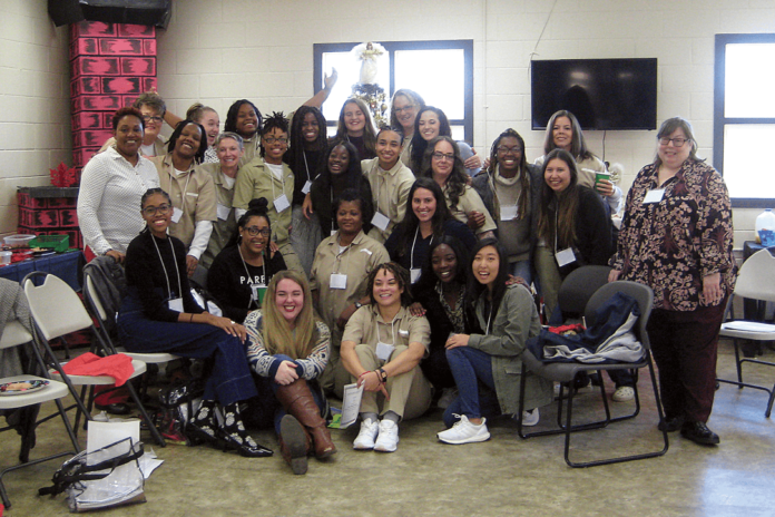 Mercer students and women incarcerated at Pulaski State Prison pose for photos during their last ‘Building Community/Inside-Out’ class together on Dec. 7.