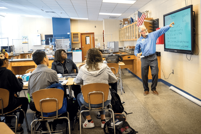Central High School physics professor Dr. Glenn Harman teaches senior IB students a lesson from a new physics curriculum in October.