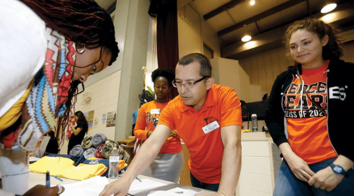 Mercer event reaches out to underserved population of Middle Georgia Dr. Jose Pino, center, talks with an attendee at the Hispanic Health Fair in February.