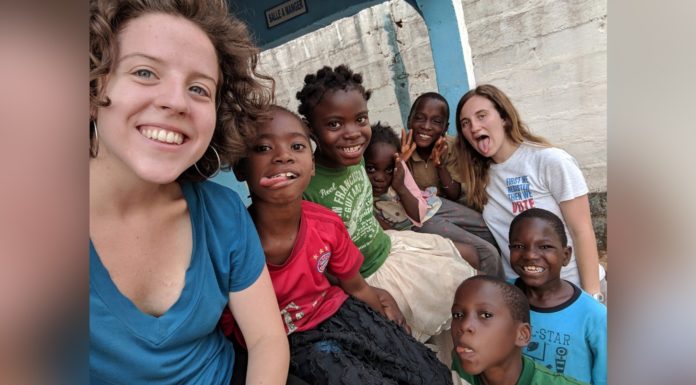 Mercer students connect with children, community during Guinea internship Sarah Harris, left, and Carrie Bezanson, right, are shown with orphans at Home of Hope in Guinea during their internship in spring 2019.