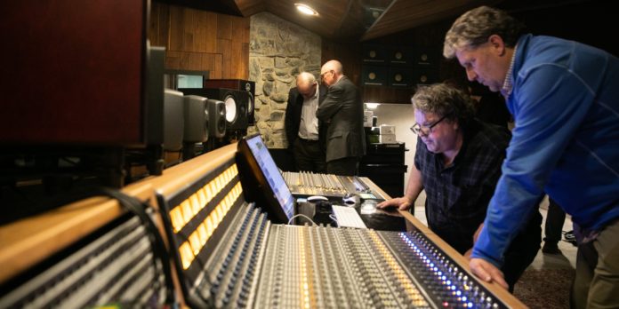 Rob Evans and Steve Ivey work on the API sound console at Mercer Music at Capricorn