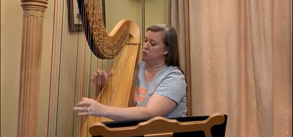 Calista Anne Koch plays the harp.