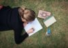 How to study for finals when you’re already mentally exhausted | Ask Kelly Woman studying while laying on the grass