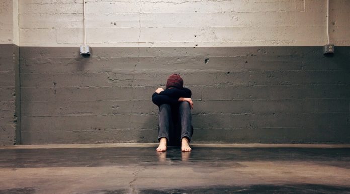 5 tips to help handle excessive worry related to coronavirus alone man sitting against wall