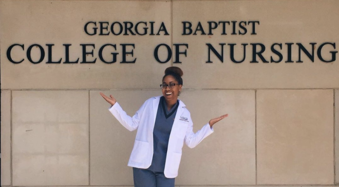 Alumna travels to New York to work as crisis nurse Mica David in front of Georgia Baptist College of Nursing sign