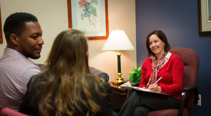 Mercer Family Therapy Center uses telehealth to connect with clients A man and woman talk to a therapist