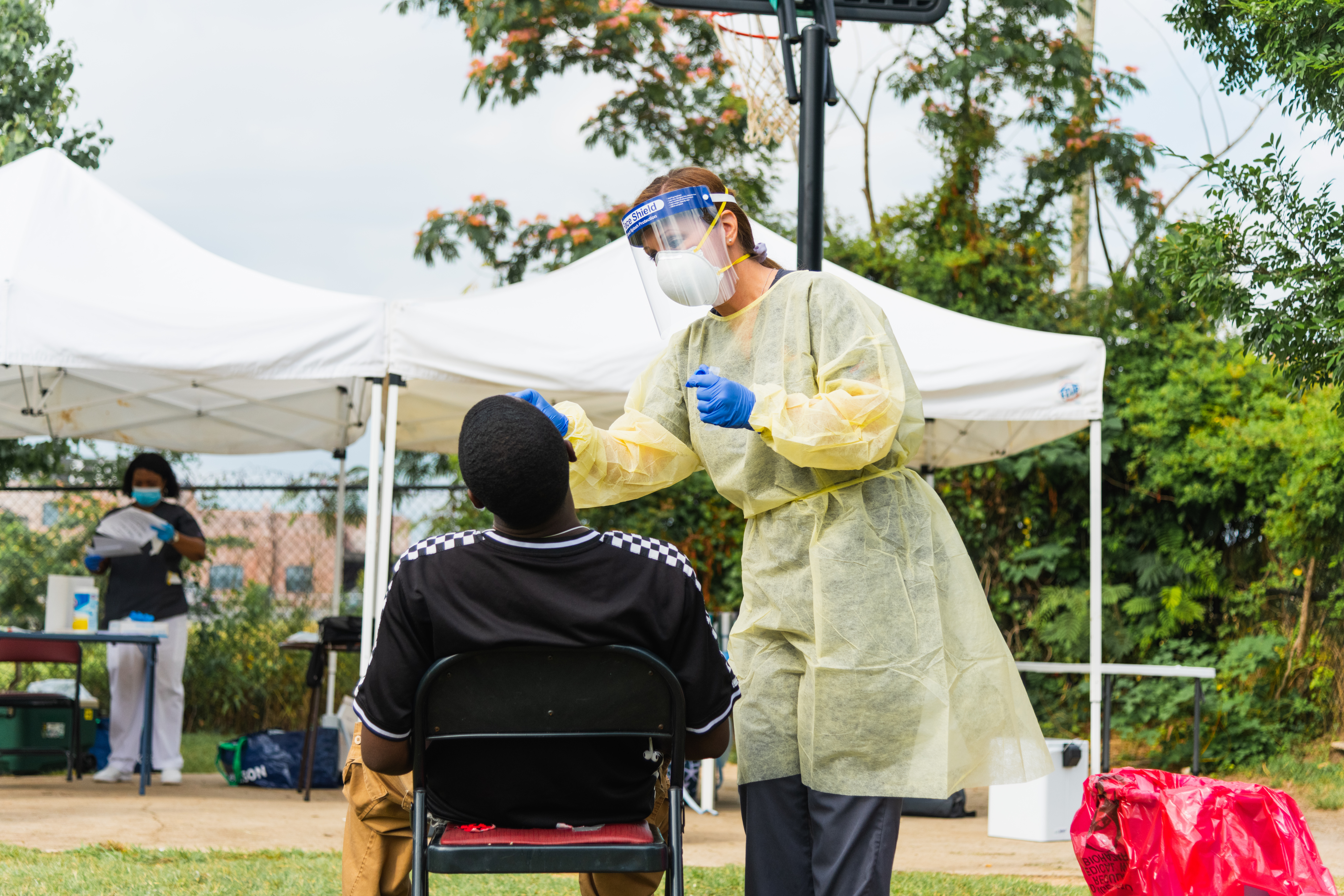 A Mercer Medicine team member tests a man for COVID-19 during at Daybreak Day Resource Center on June 4, 2020.