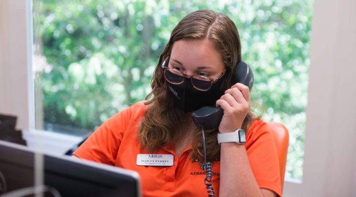 Mercer is requiring masks on campus. Here’s when to wear them Student talks on telephone while wearing a mask