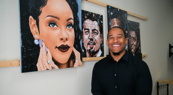 Alumnus paints portraits of cultural icons | Mercer Made Caleb Brown stands in front of his paintings
