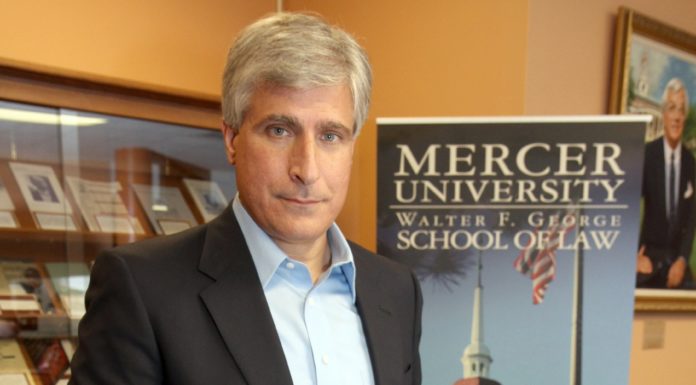 Law graduate is New York Times best-selling author | Mercer Made Steve Berry holds his book, The Jefferson Key