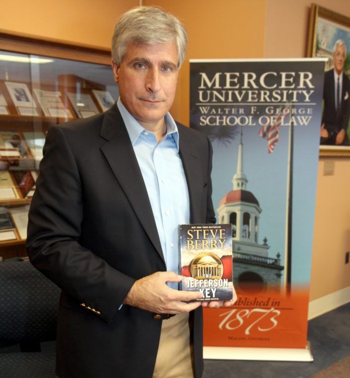 Steve Berry holds his book, The Jefferson Key