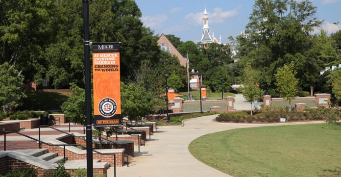 A banner on Mercer's campus reads: At Mercer, everyone majors in changing the world
