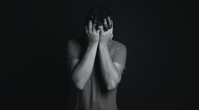 How to better manage your emotions during a crisis Man with head in hands