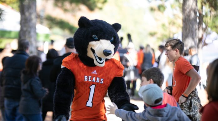 Homecoming celebration moved to October Toby high fives children during Bear Walk