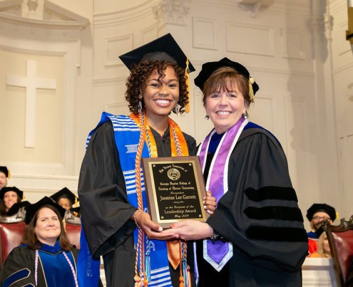 Jasmine Ellington is pictured with College of Nursing Dean Linda Streit after winning the leadership award during graduation in May 2019.