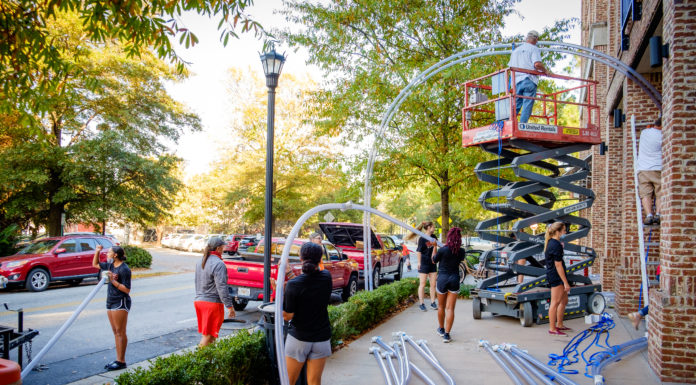 Holiday light show moves to Mercer Village Mercer softball team members assist with installation of the light show in Mercer Village on Nov. 13.