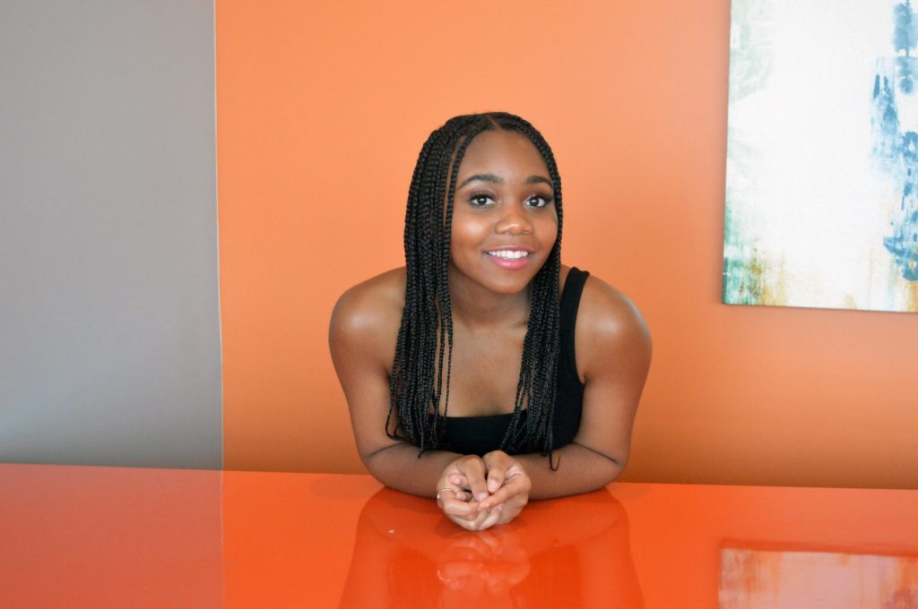Melody Gervin in front of an orange wall