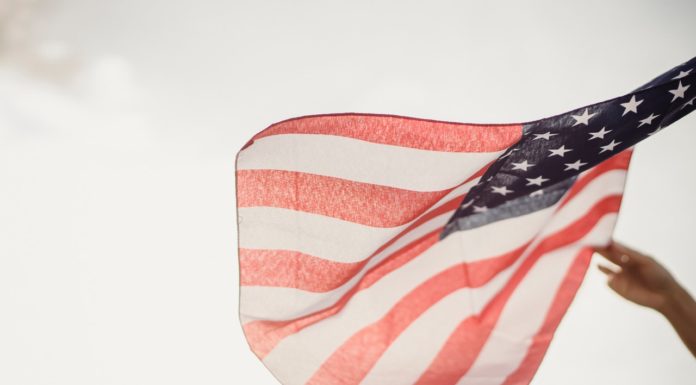 How to salvage a relationship divided over politics | Ask Kelly A flag blows in the wind