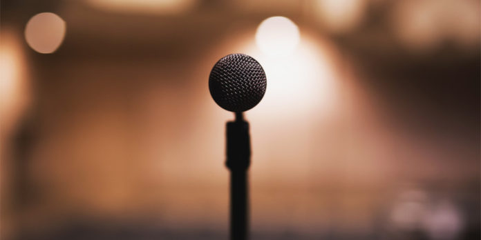 a microphone overlooking a bright auditorium