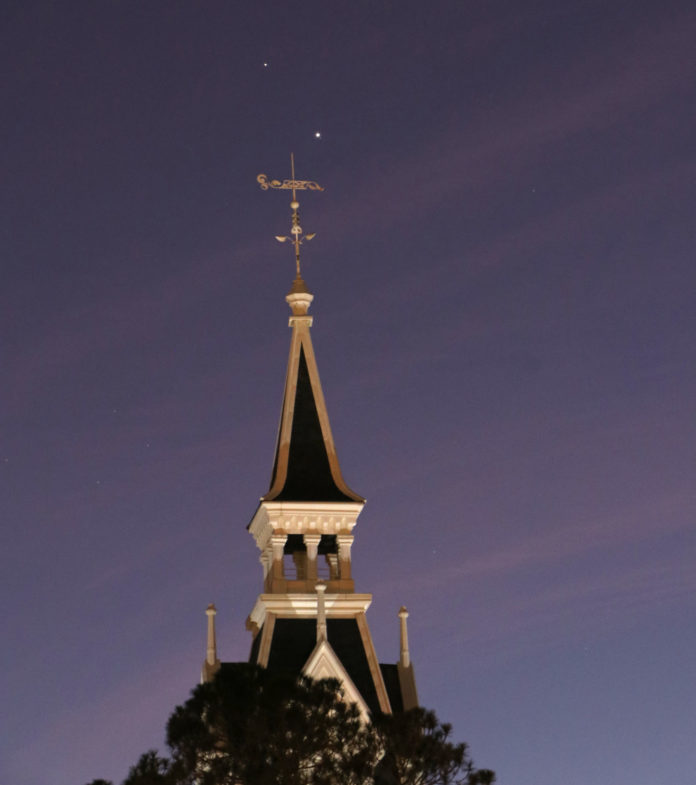 (Photo by Matt and Hanny Marone) A view of the Administration Building with Jupiter and Saturn in the sky on Dec. 9.