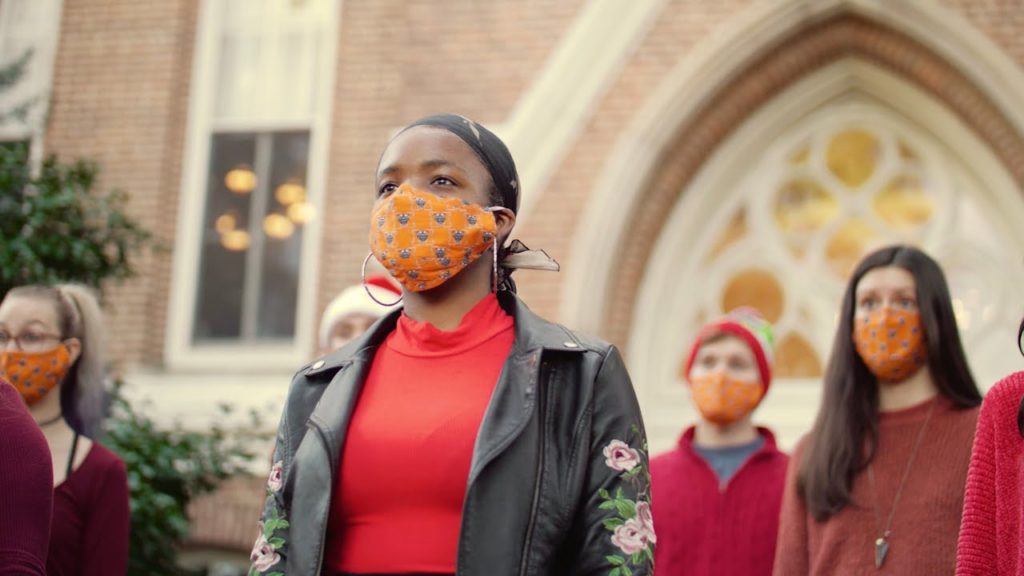 students sing in masks outside