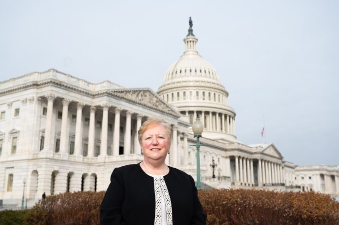 Catherine Szpindor stands in front of the U.S. Capitol