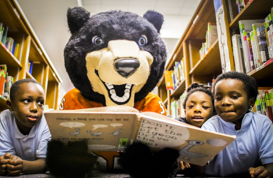 Toby reads to children in the United Way's Read United/Read2Succeed program. (Photo taken prior to COVID-19)