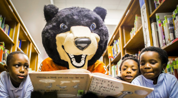 First-year student-athletes learn ‘importance of being leaders in service’ | Classroom Spotlight Toby reads to children in the United Way's Read United/Read2Succeed program. (Photo taken prior to COVID-19)