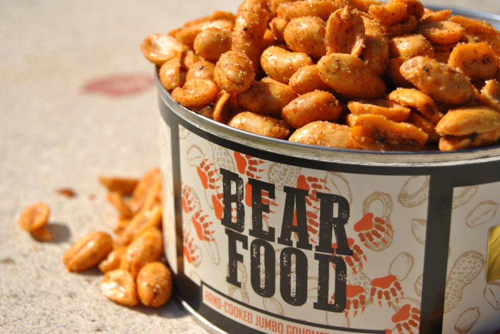 A tin of peanuts that says "Bear Food" on it