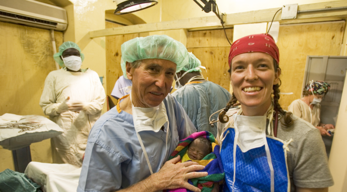 Dr. Richard Furman built foundation for career, family and faith at Mercer Dr. Richard Furman is shown with a baby after a c-section in Kenya.
