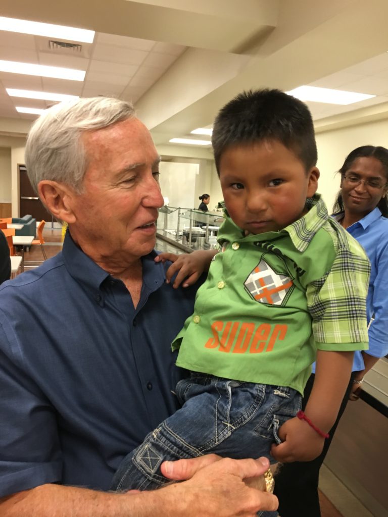 Dr. Richard Furman holds a young heart patient at one of the partner hospitals of World Medical Mission.