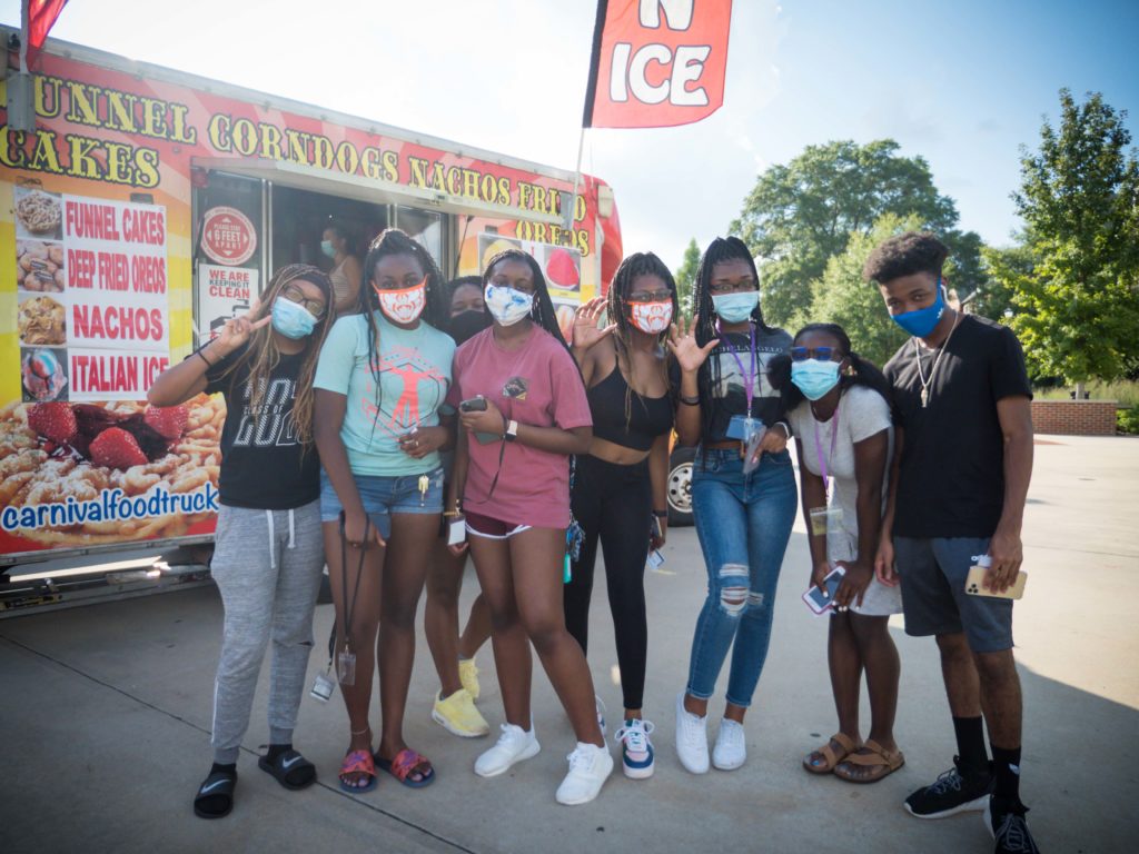 Mercer students are pictured by a food truck during the the Minority Mentor Program's multicultural night during pre-orientation week in summer 2020. 