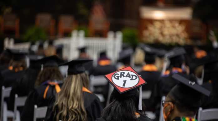How to decide if grad school is right for you | How Do You Do That? rear view of graduates in cap and gowns at commencement
