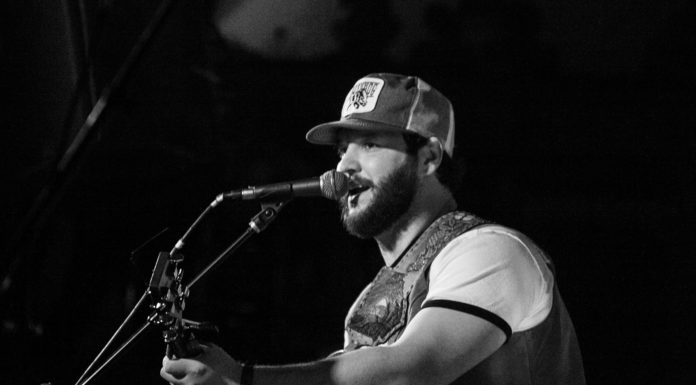 Law alumnus JB Strauss breaks into music industry, plans to record at Capricorn JB Strauss plays guitar and sings into a microphone