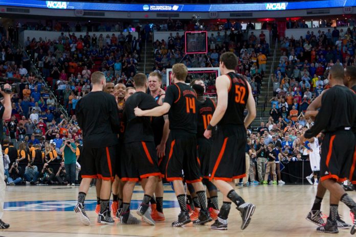 Mercer basketball players celebrate a win on the court
