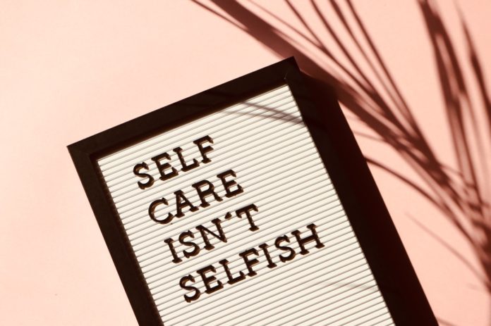 A sign reads: Self Care Isn't Selfish