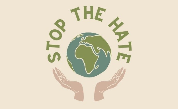 a globe rests in open hands with the words stop the hate around it