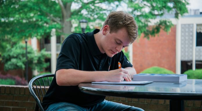 College of Professional Advancement workshops strengthen student writing skills a college student sits at a table writing