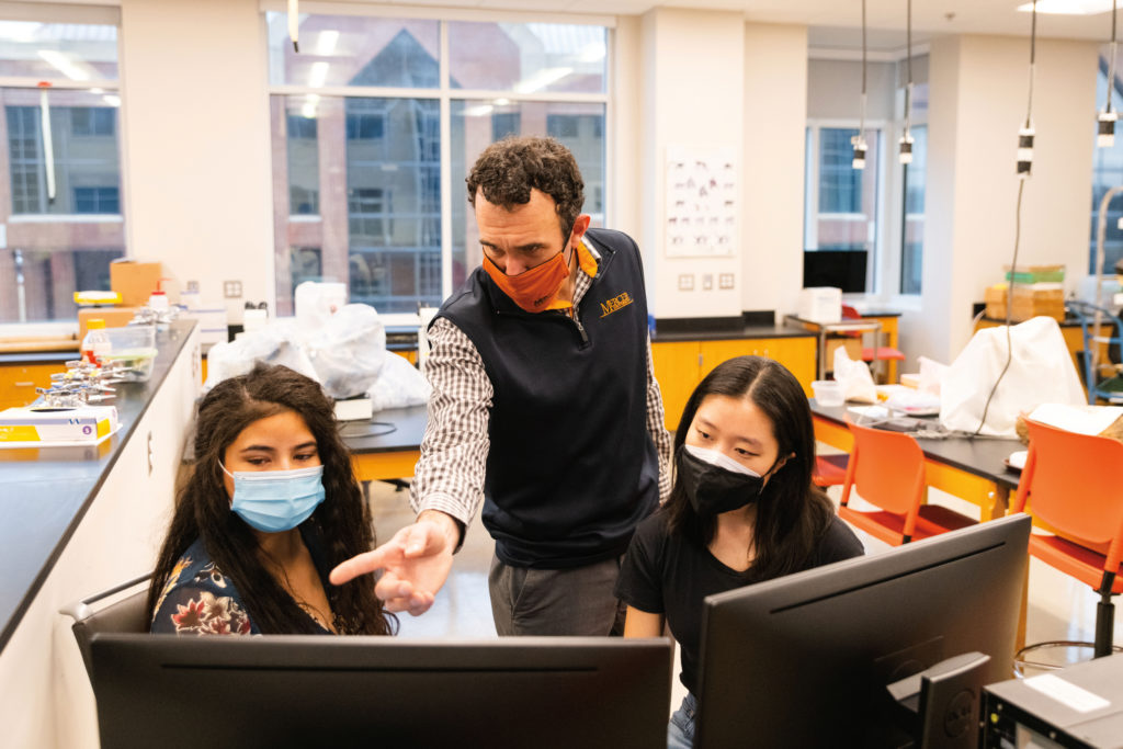 Right, Professor of Chemistry Kevin Bucholtz (center) serves as director of undergraduate research at Mercer.