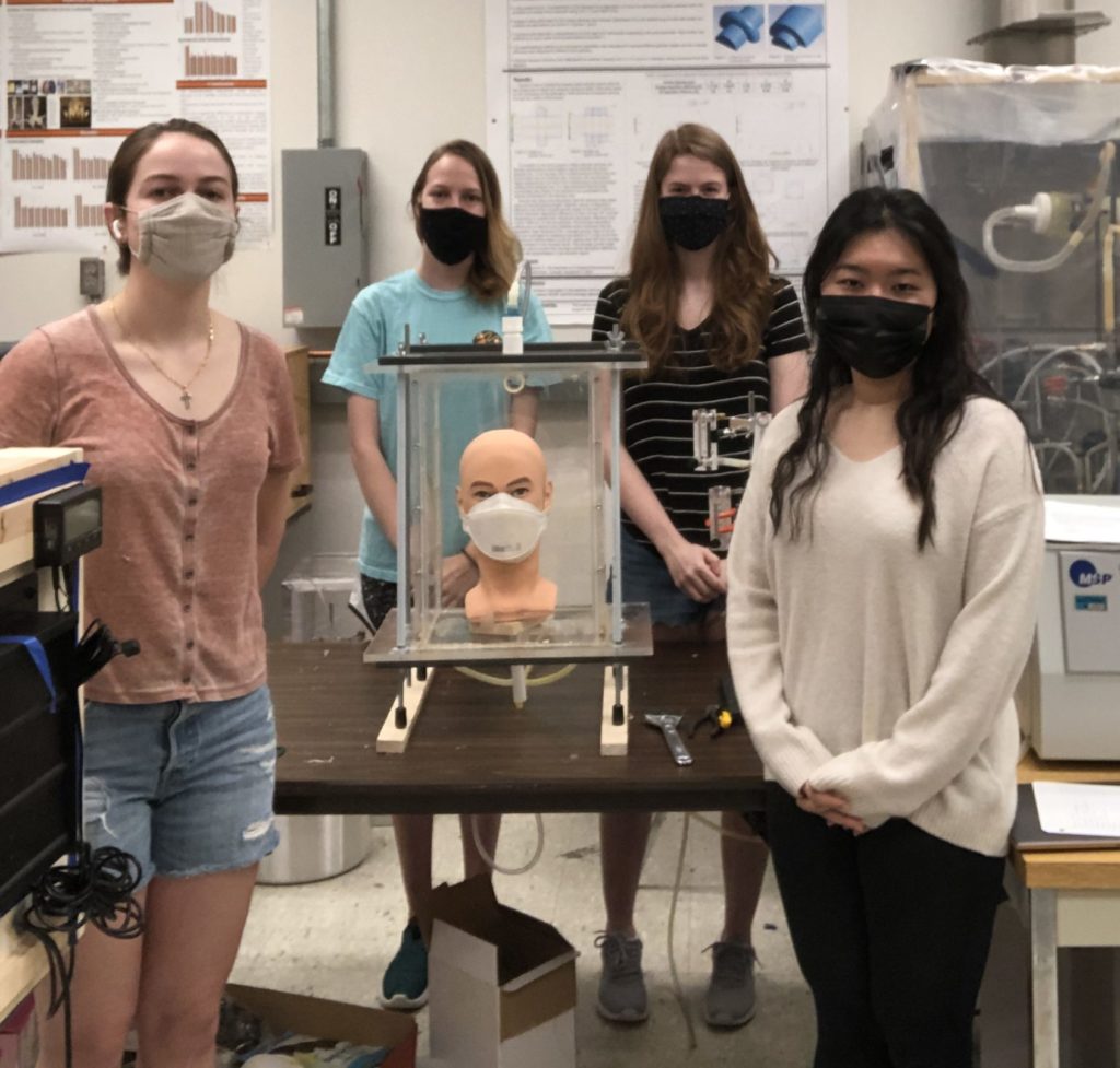 Sarah Spalding (third from left) and her team work on their mask research in the lab. 