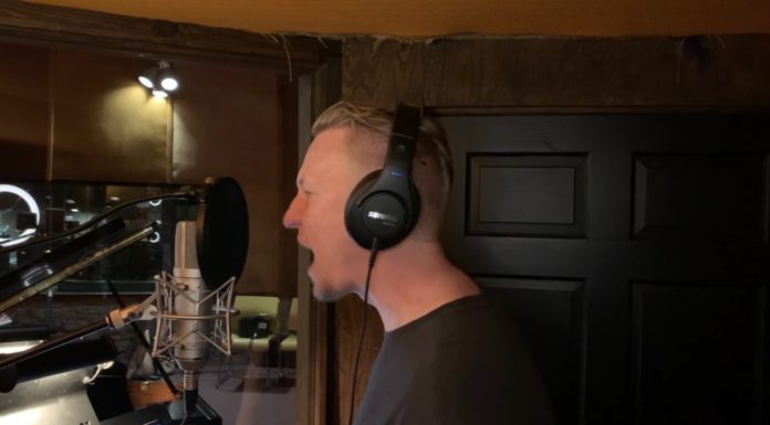 Professor records old hymns in punk rock style at Capricorn Sound Studios a man sings into a microphone