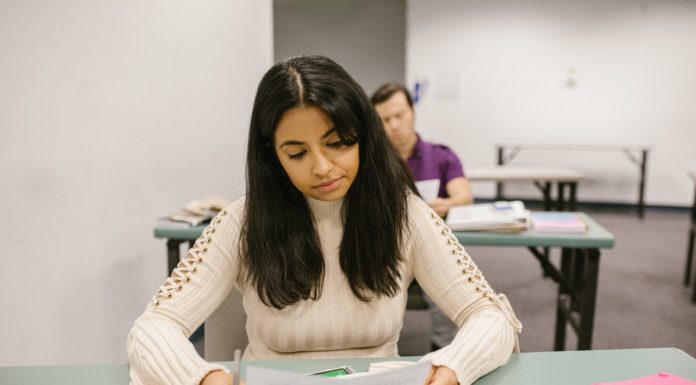 How to regroup after failing a college course | Ask Kelly girl sitting at a desk looks disappointedly at a graded paper