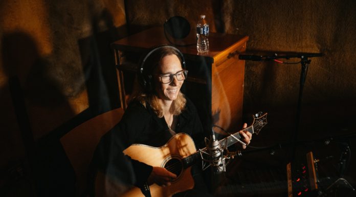 Mercer professors’ band records at legendary Capricorn Sound Studios a woman plays the guitar