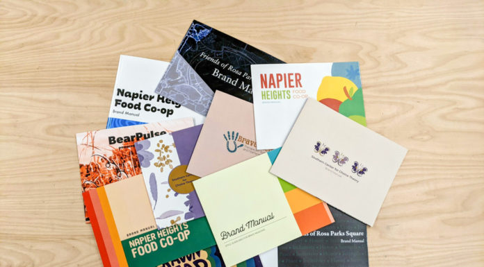 Advanced design students help nonprofits with branding | Classroom Spotlight Brand manuals scattered on a wooden table