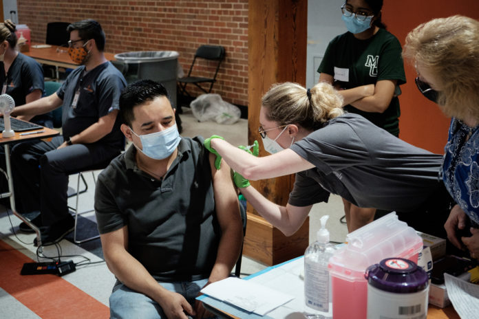 A community member receives the COVID-19 vaccine during a vaccination clinic for the Hispanic community on the Macon campus on July 15.