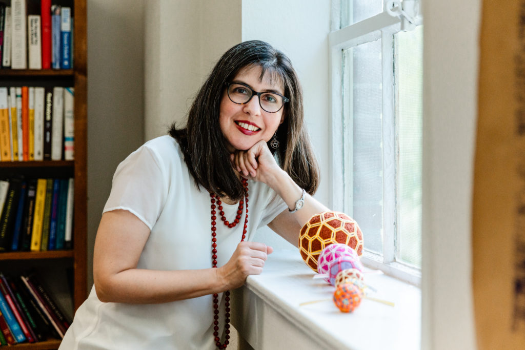 Dr. Carolyn Yackel is pictured with some of the temari balls she created for the “Mathemalchemy" project.